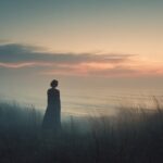 Woman standing in tall grass at sunrise, symbolizing daring to imagine and awakening to new possibilities