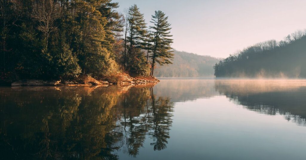 Calm water reflecting light and sky, symbolizing soulful reflections and inner clarity.