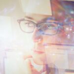 A woman staring at multiple screens, looking bewildered as she works through the challenges of building a site with Elementor